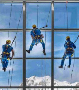 acrobatica team cleaning building using rope access